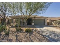 Charming single-story home featuring desert landscaping, a covered entry, and a two-car garage at 4315 W Phalen Dr, New River, AZ 85087