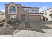 Charming two-story home with a stone facade, arched entry, and well-manicured landscaping at 4321 E Zion Way, Chandler, AZ 85249
