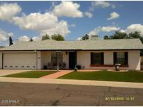 Charming single-story home with a well-maintained front yard and white garage door at 4606 E Cheyenne Dr, Phoenix, AZ 85044