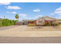 Charming single-story home featuring a brick exterior, desert landscaping, and a covered carport at 4901 N 85Th St, Scottsdale, AZ 85251