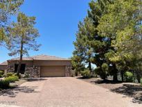 Charming home featuring a stone accent wall and a spacious two-car garage and desert landscaping at 6832 S 38Th S Pl, Phoenix, AZ 85042