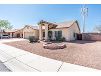 Inviting single-story home with a well-maintained, low-maintenance front yard landscape at 8818 N 110Th Ave, Peoria, AZ 85345