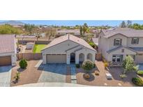 Beautiful single-story home featuring a landscaped yard and a two-car garage at 993 E Knightsbridge Way, Gilbert, AZ 85297