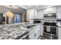 Modern kitchen features stainless steel appliances, granite countertops, and ample cabinet space at 11011 N 92Nd St # 1157, Scottsdale, AZ 85260