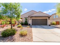 Charming single-story home with a well-maintained front yard and a two car garage at 11023 E Shepperd Ave, Mesa, AZ 85212