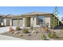 Charming one-story home with a well-manicured desert landscaped front yard and an attached two-car garage at 13418 W Mayberry Trl, Peoria, AZ 85383