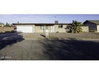 Charming single-story home with desert landscaping, attached garage, and a quaint front yard at 1518 N Gilbert Ave, Casa Grande, AZ 85122