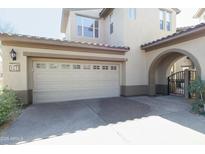 Attached two car garage, paved drive, and gated entrance, providing convenient parking and security at 20802 N Grayhawk Dr # 1151, Scottsdale, AZ 85255