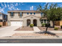 Charming two-story home featuring a two-car garage, landscaped yard, and a welcoming front porch at 21030 E Misty Ln, Queen Creek, AZ 85142