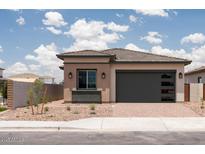 Charming single-story home with a tan exterior, desert landscaping, and a two-car garage at 338 E Las Perlas Ln, San Tan Valley, AZ 85140