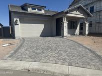 Charming single-story home showcasing a paved driveway leading to a two-car garage at 3746 E Rochelle Cir, Mesa, AZ 85215