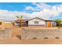 Charming single-story home with a palm tree, block wall, and a covered carport at 4031 N 81St Ave, Phoenix, AZ 85033