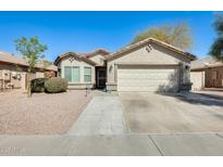 Charming single-story home featuring a two-car garage and a low maintenance desert landscape at 4332 W Carson Rd, Laveen, AZ 85339