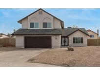 Charming two-story home with a two-car garage and desert landscaping in a quiet neighborhood at 7637 W North Ln, Peoria, AZ 85345