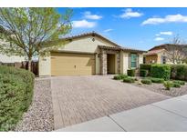 Charming home with a well-manicured front yard, brick driveway, and a two-car garage at 7769 S Reseda St, Gilbert, AZ 85298