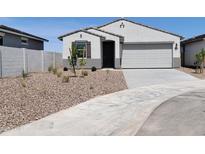 Charming single-story home with desert landscaping and a two-car garage at 8530 W Trenton Ct, Florence, AZ 85132