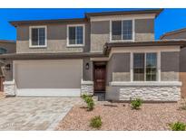 Charming two-story home with a two car garage and stone accents on the facade at 11611 W Green Dr, Youngtown, AZ 85363