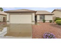 Charming single-story home featuring a two car garage and low maintenance desert landscaping at 14527 W Marcus Dr, Surprise, AZ 85374