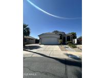 Charming single-story home with a two-car garage and well-manicured landscaping in a residential neighborhood at 19980 N 63Rd Dr, Glendale, AZ 85308