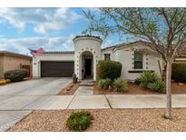 Charming home featuring a turret entryway, desert landscaping, and a two-car garage at 22452 E Calle De Flores --, Queen Creek, AZ 85142