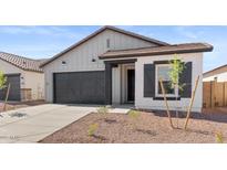 Charming single-Gathering home showcasing a gray facade, black trim, and a well-manicured front yard with a concrete driveway at 23435 W Albeniz Pl, Buckeye, AZ 85326
