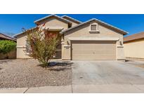 Inviting single-Gathering home featuring desert landscaping and a two-car garage on a sunny day at 24824 W Pueblo Ave, Buckeye, AZ 85326