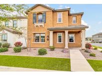 Inviting two-story home featuring a well-manicured lawn and charming exterior details at 2708 S Santa Rita --, Mesa, AZ 85209