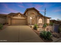 Charming two-story home features a desert landscaped front yard and attached two-car garage at 4903 S Desert Willow Dr, Gold Canyon, AZ 85118