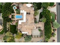 Expansive property featuring a tile roof, manicured lawns, a large pool, and a circular driveway at 6402 E Chaparral Rd, Paradise Valley, AZ 85253