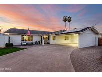 Charming single-story home with an ample driveway, palm trees and lovely sunset colors at 6718 N 19Th Pl, Phoenix, AZ 85016