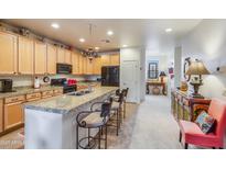 Well-appointed kitchen with granite counters, breakfast bar, and modern appliances at 10655 N 9Th St # 207, Phoenix, AZ 85020