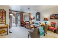 Bright living room with comfy seating and balcony access, perfect for relaxing and entertaining at 10655 N 9Th St # 207, Phoenix, AZ 85020