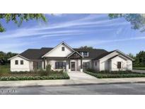 Charming single-story home boasts symmetrical design, inviting entry, and black roof at 12373 W Blackhawk Rd, Casa Grande, AZ 85194