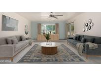 Bright living room featuring stylish sofas, modern decor, and a large area rug over carpet at 12939 W Prospect Dr, Sun City West, AZ 85375