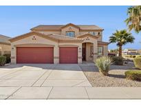 Charming two-story home featuring a three-car garage and a well-manicured front yard with desert landscaping at 1775 W Green Tree Dr, San Tan Valley, AZ 85144