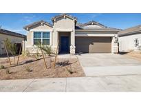 Charming single-story home with a tan exterior, front yard landscaping, and a two-car garage at 25364 W Sunland Ave, Buckeye, AZ 85326