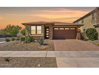 Charming single-story home with desert landscaping, brick driveway, and a welcoming front entrance at 25424 S 224Th Pl, Queen Creek, AZ 85142