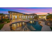 Beautiful backyard showcasing a sparkling pool, covered patio, and manicured landscaping, perfect for outdoor living at 3953 E Lafayette Ave, Gilbert, AZ 85298