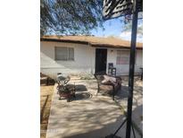 Outdoor patio with a metal fire pit, chairs, and a basketball hoop, perfect for entertaining at 4610 W Indianola Ave, Phoenix, AZ 85031