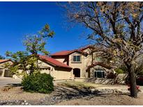 Charming two-story home with a red tile roof and a well-manicured front yard at 4750 W Saddlehorn Rd, Phoenix, AZ 85083