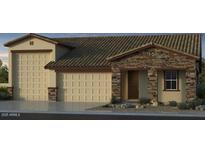 Charming home featuring a three-car garage, a stone facade, and a covered entryway at 5445 N 178Th Ave, Litchfield Park, AZ 85340