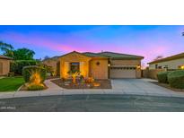 Charming single-story home with landscaped front yard and a two-car garage, captured at twilight at 5632 S Four Peaks Pl, Chandler, AZ 85249