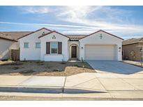 Charming single-story home with a symmetrical facade, a terracotta roof, and a two-car garage at 5733 W Saint Moritz Ln, Glendale, AZ 85306