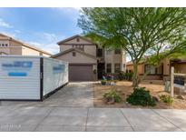 Charming two-story home featuring a landscaped front yard, a cozy sitting area, and a two-car garage at 6785 W Tether Trl, Peoria, AZ 85383