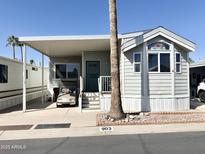 Charming home featuring a covered parking area and a well-maintained landscaped front yard at 903 S Mineshaft Dr, Apache Junction, AZ 85119