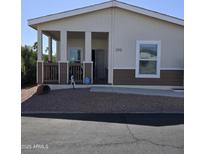 Charming single-story home with a welcoming covered porch and well-maintained gravel landscaping at 11596 W Sierra Dawn Blvd # 293, Surprise, AZ 85378
