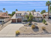 Beautiful two-story home with a tile roof, desert landscaping, and a spacious three-car garage at 15755 E Palomino Blvd, Fountain Hills, AZ 85268