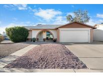Charming single-Gathering home featuring a two-car garage and low maintenance desert landscaping at 17234 N Paradise Park Dr, Phoenix, AZ 85032