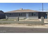 Charming single-story home with a low-walled yard, showcasing a neat and inviting facade under a clear sky at 2010 N 38Th Ave, Phoenix, AZ 85009