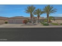 Well-maintained home featuring desert landscaping and a three car garage at 20416 N Palm Canyon Dr, Surprise, AZ 85374